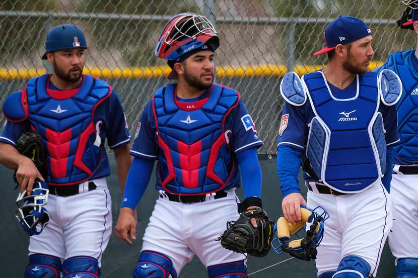 Texas Rangers catchers (from left) Isiah Kiner-Falefa, Jose Trevino and Jeff Mathis prepare...
