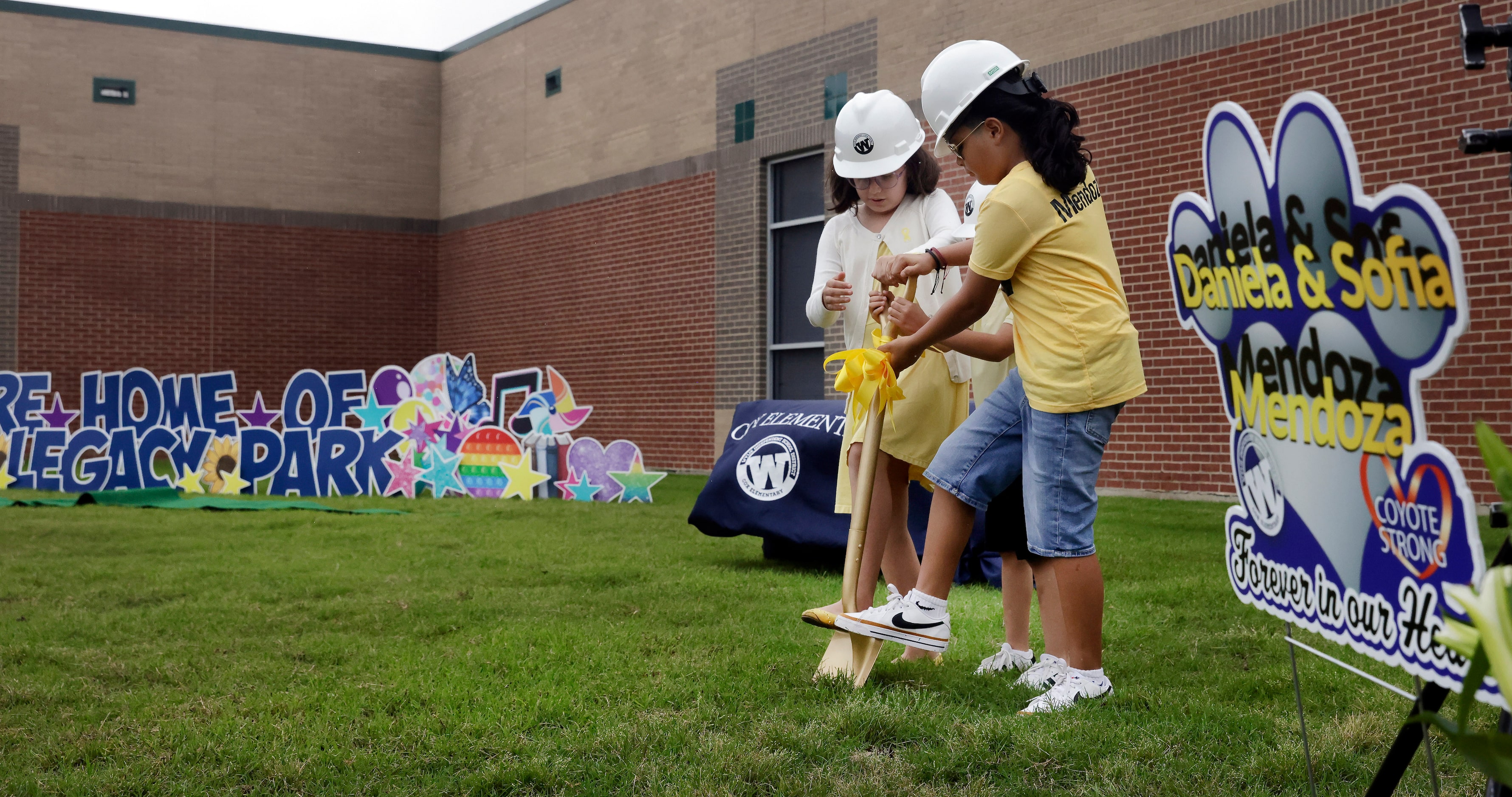 In remembrance of Daniela and Sofia Mendoza, third graders Isabel Baez (left) and Jeremiah...