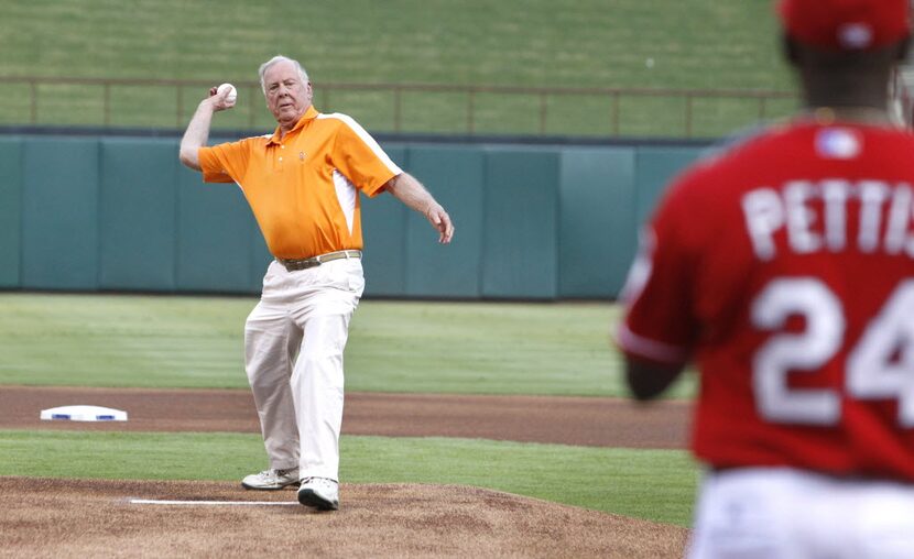 T. Boone Pickens throws out the ceremonial first pitch to Rangers coach Gary Pettis before...