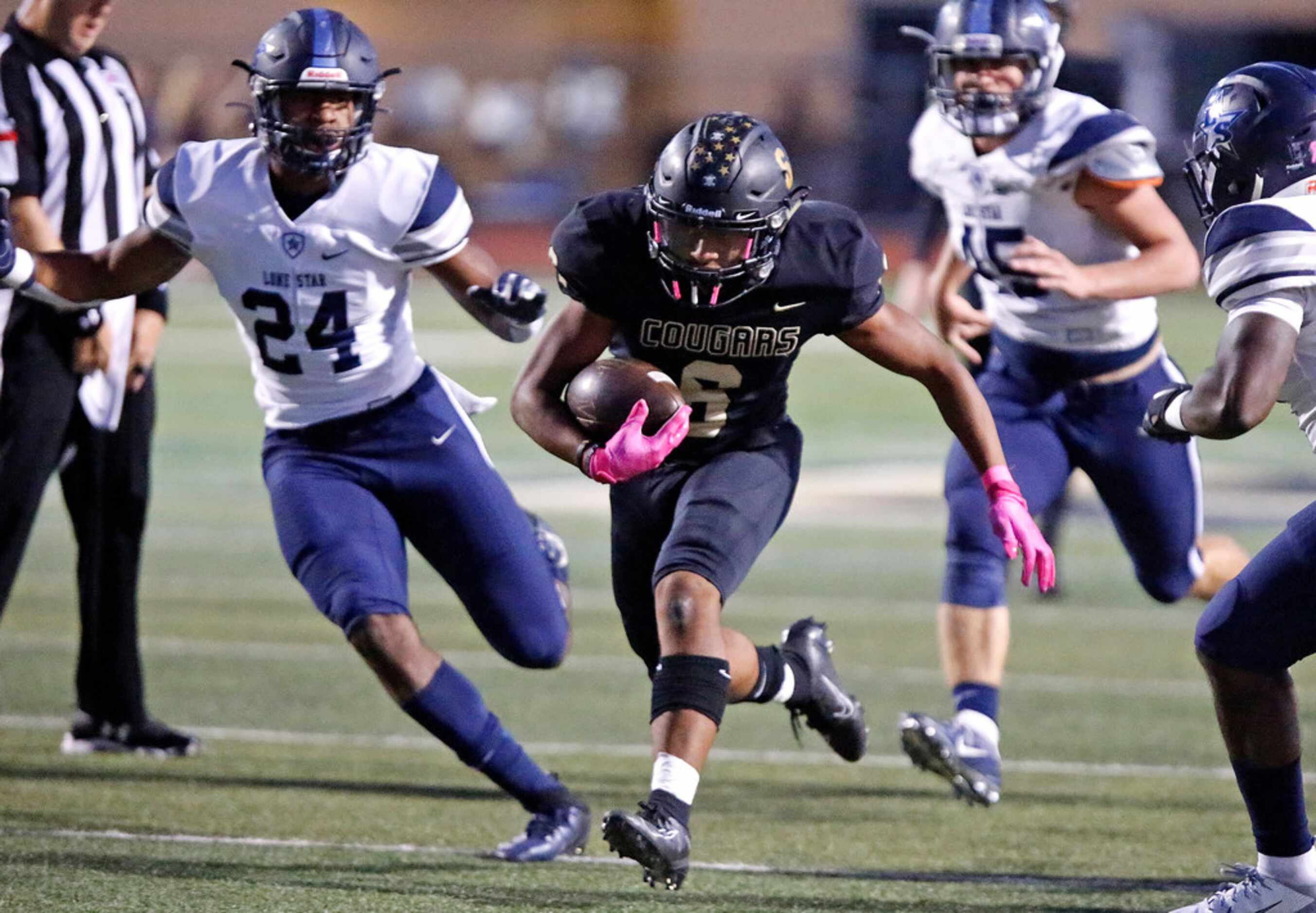 The Colony High School running back Kamden Wesley (6) runs in front of Lone Star High School...