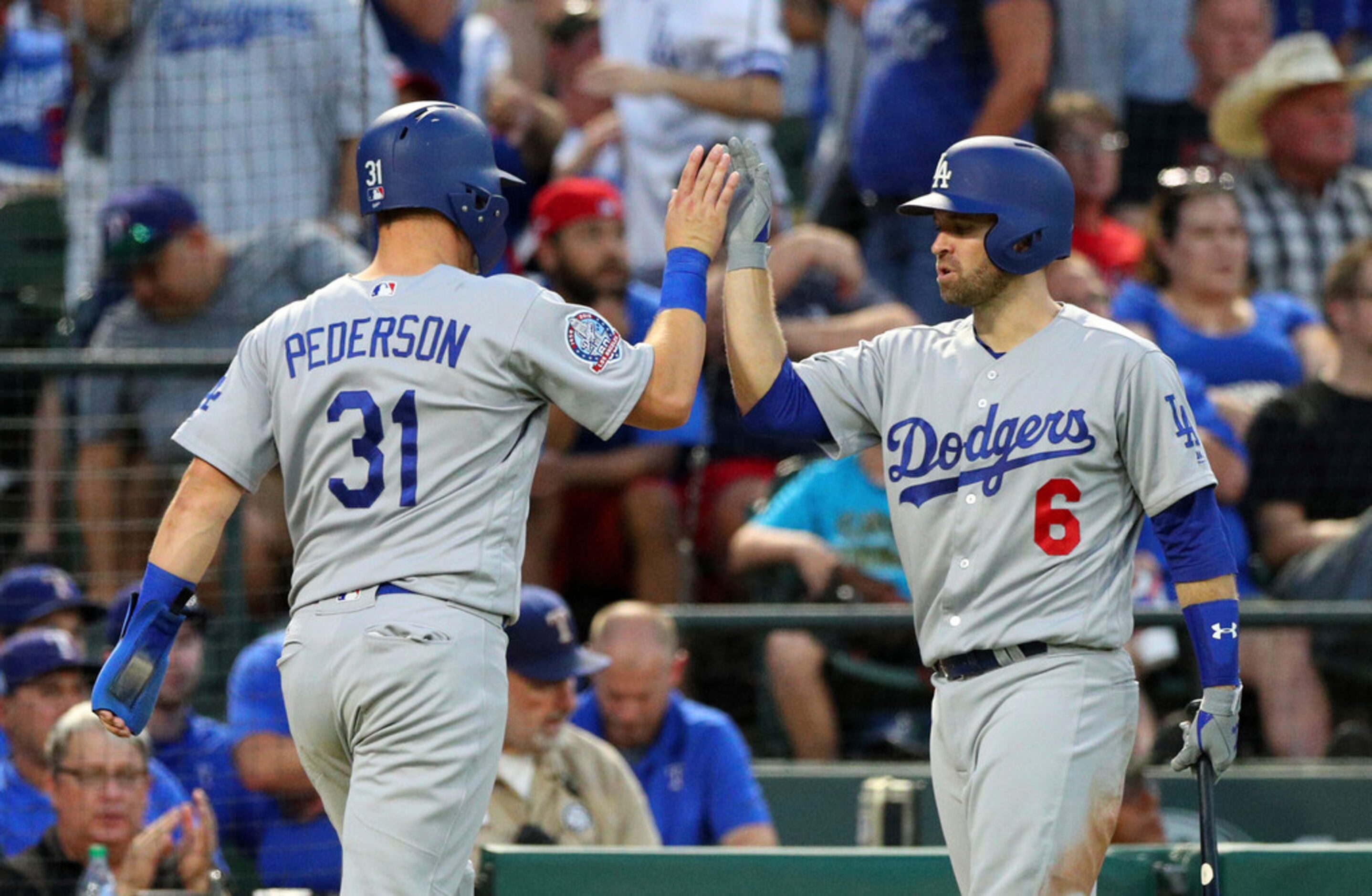 Los Angeles Dodgers' Joc Pederson (31) high fives Brian Dozier after scoring against the...