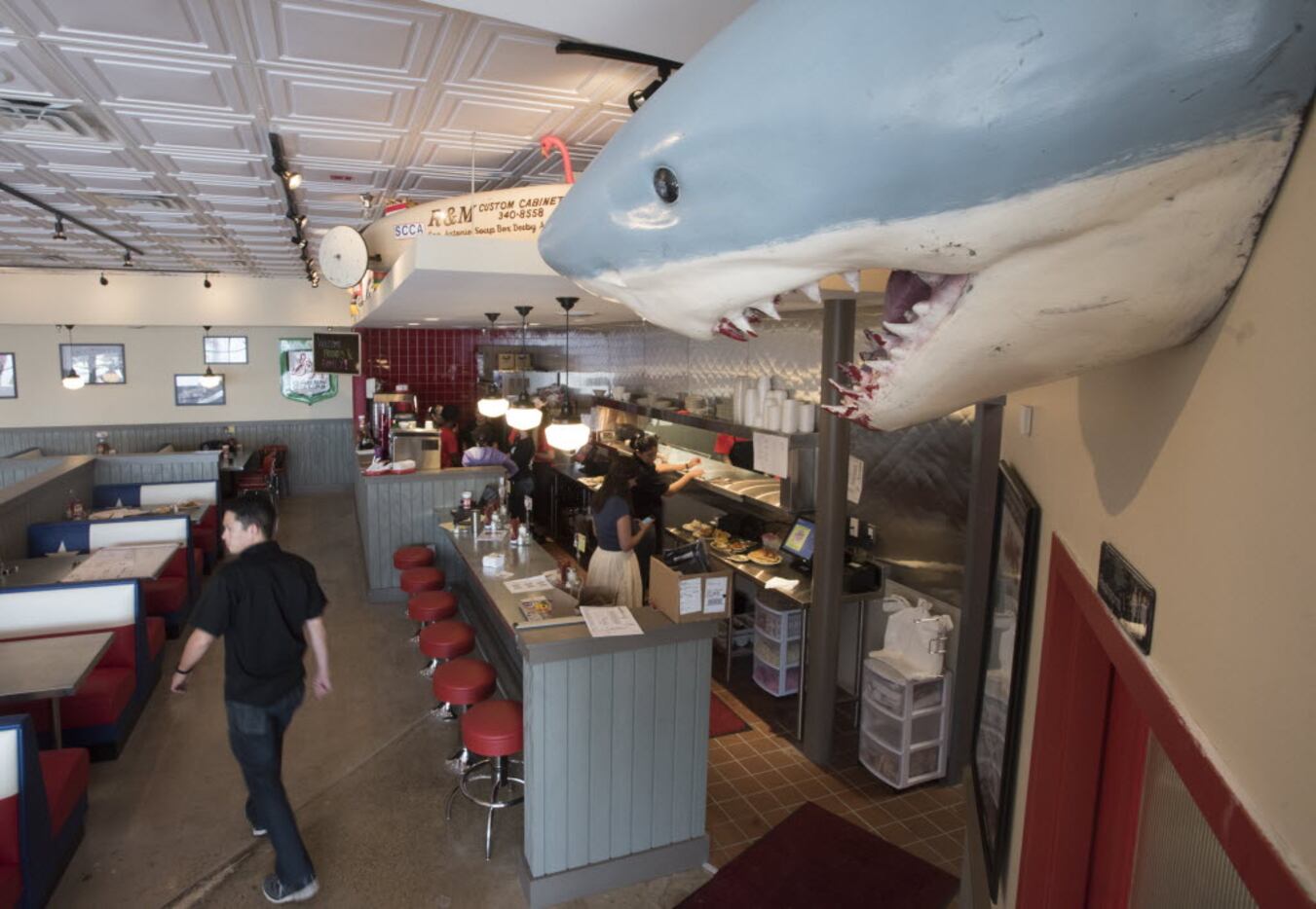 A fake shark hangs over the dining room at the newest location of Norma's Cafe in Caruth...