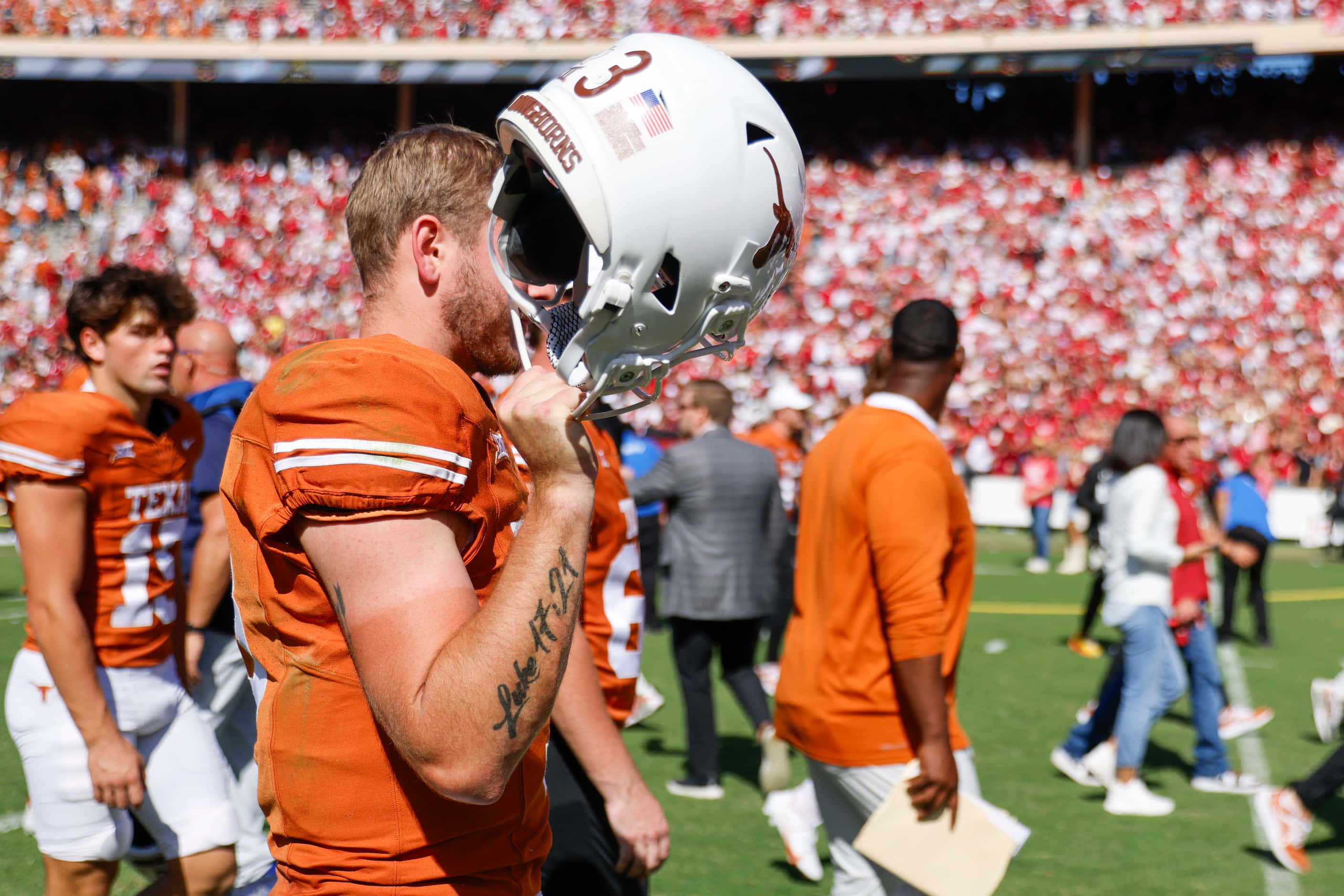 Texas quarterback Quinn Ewers shields his face from the camera after Texas lost to Oklahoma...