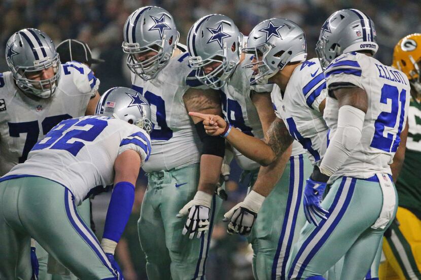Dallas Cowboys quarterback Dak Prescott (4) calls the play in the huddle during Cowboys NFL...