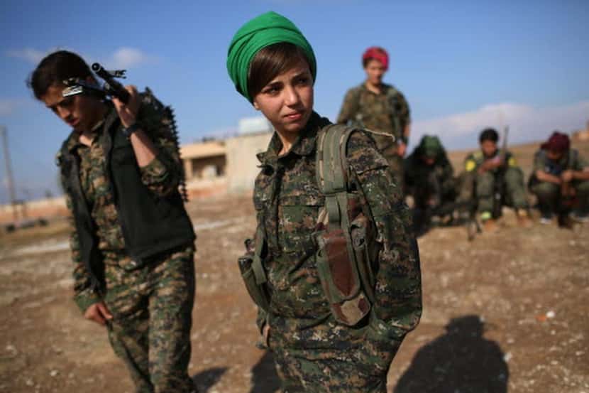 
Kurdish female troops from the Syrian Democratic Forces stand in a forward operating base...