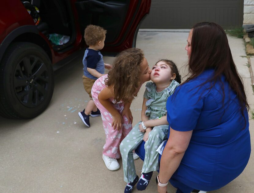 Lincoln Brooks kissed big sister Charlotte as they arrived home in Sherman on Aug. 10, 2022.