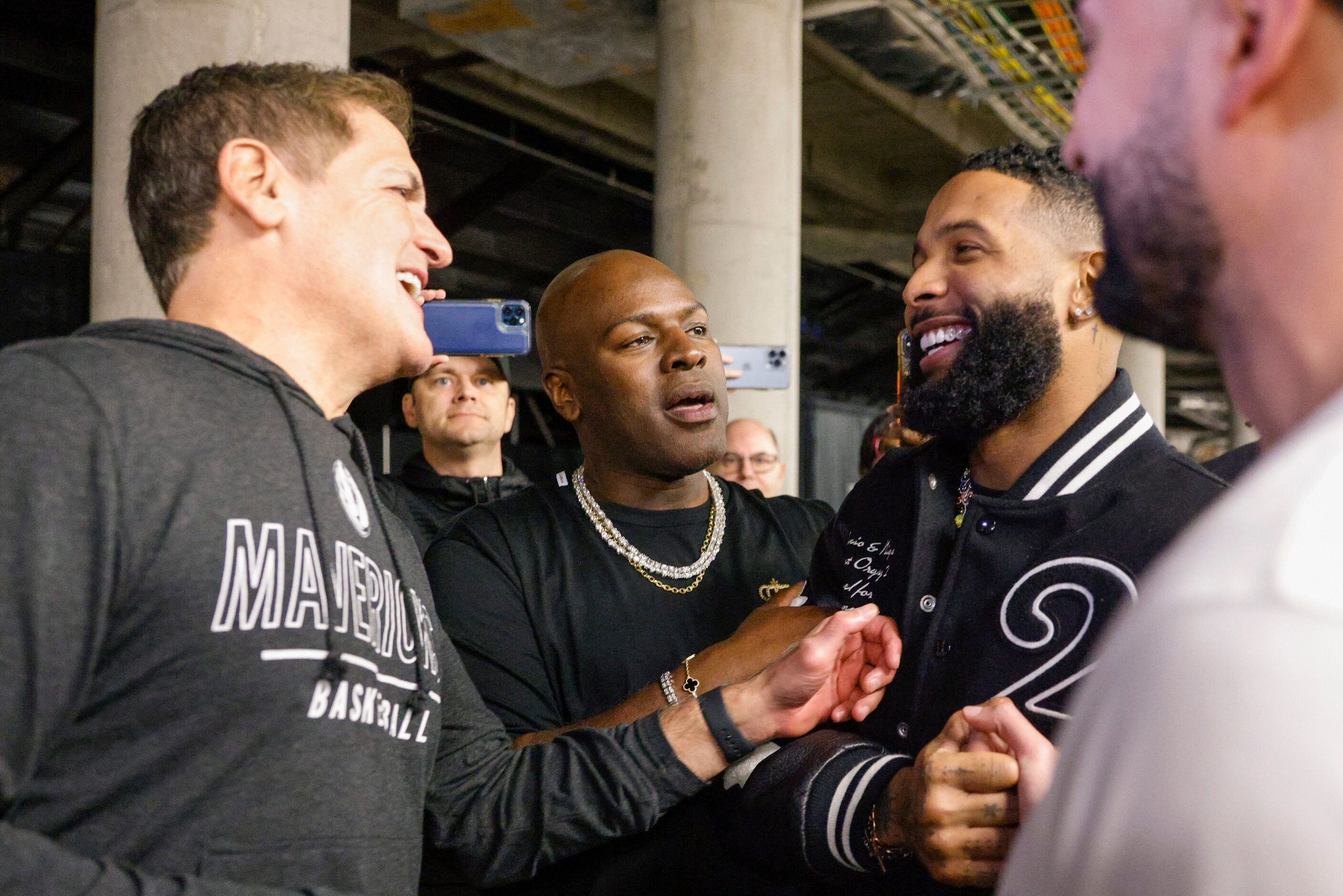 Dallas Mavericks owner Mark Cuban (left) talks with business executive and talent manager...