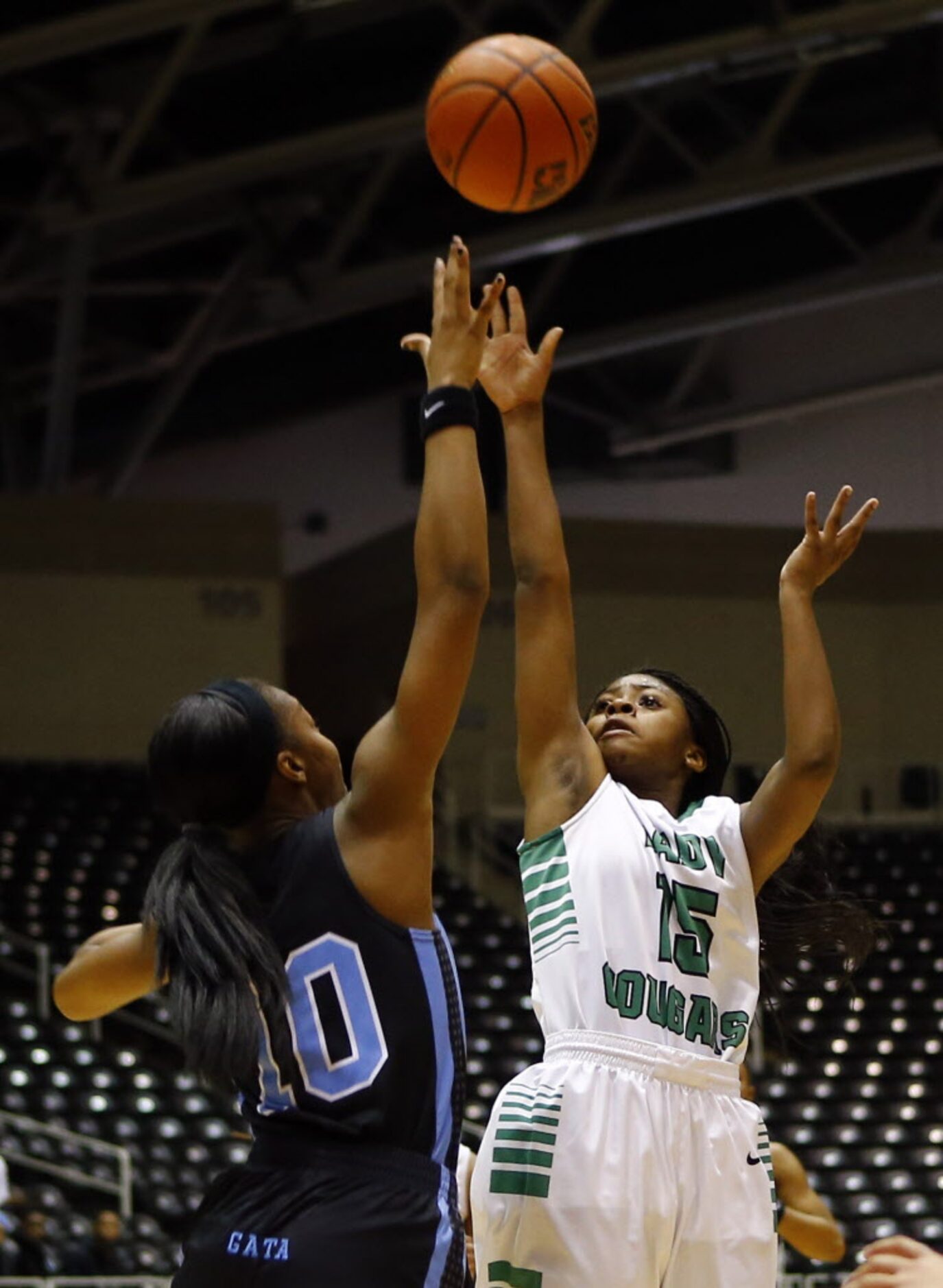 Bryan Adams' DeBrashia Baty (15) shoots over Arlington Seguin's Khilyn Cooper (10) during...