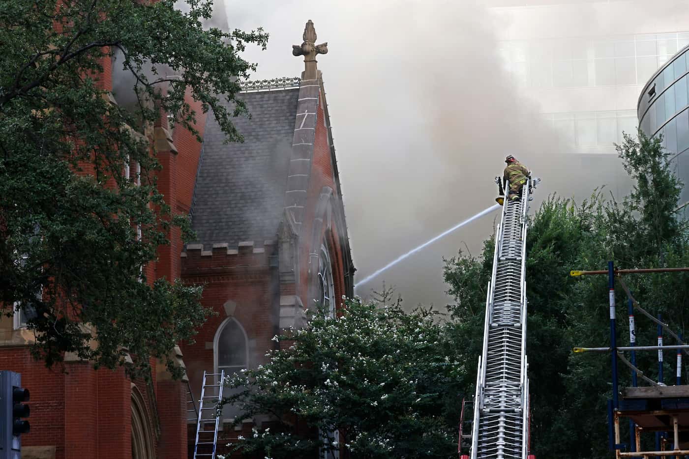 Firefighters work at the scene of a fire at First Baptist Dallas church on Friday, July 19,...