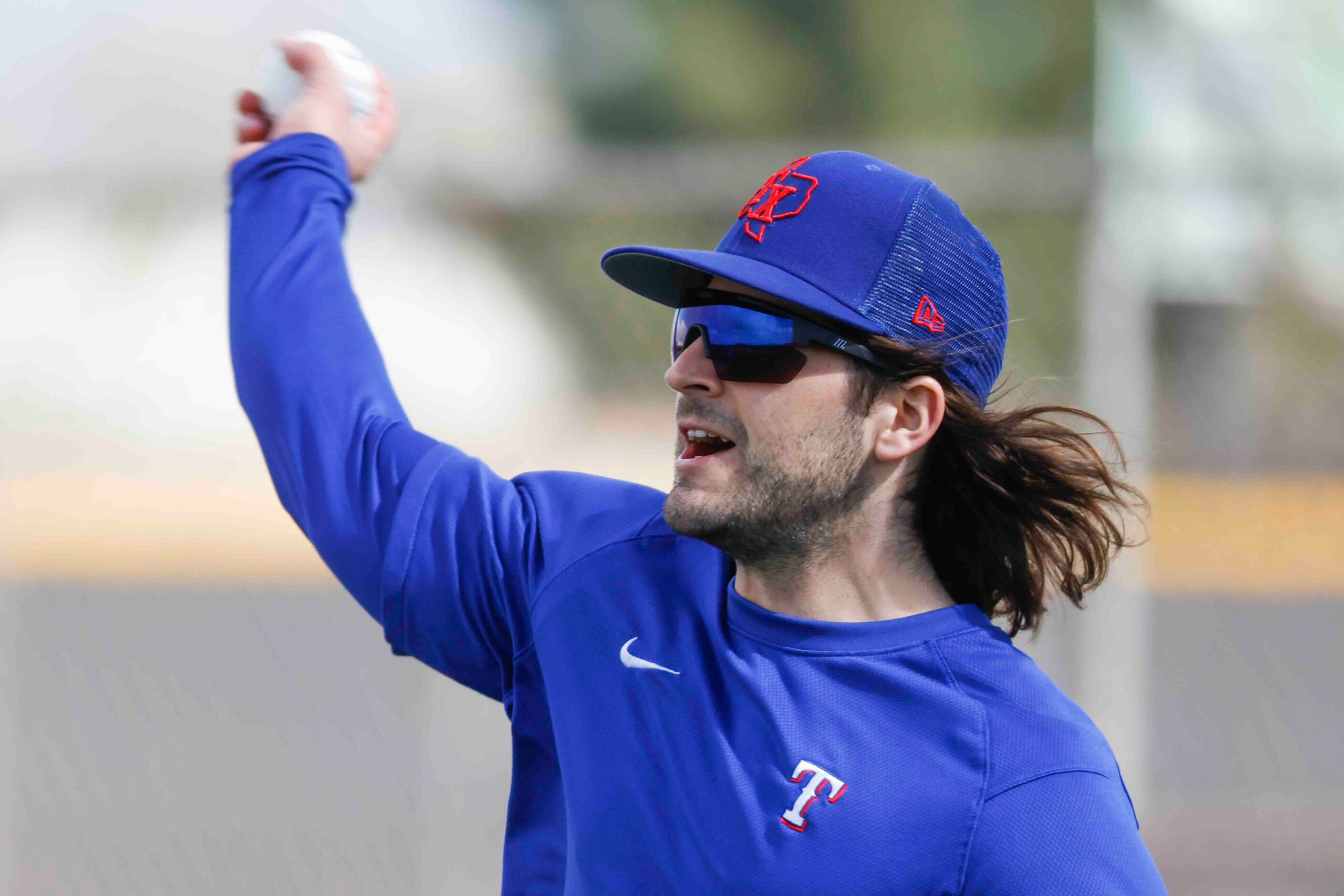 Texas Rangers infielder Josh Smith takes part in a fielding drill during a spring training...