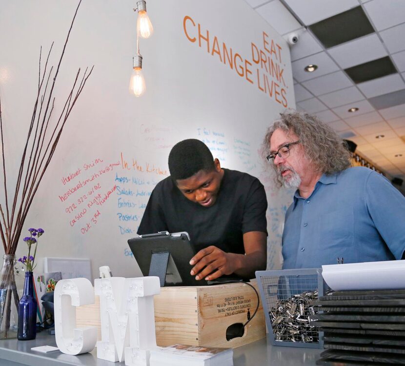 
Malik Runnels (left) asks a question to Kenneth Pyron, director of operation at Café...