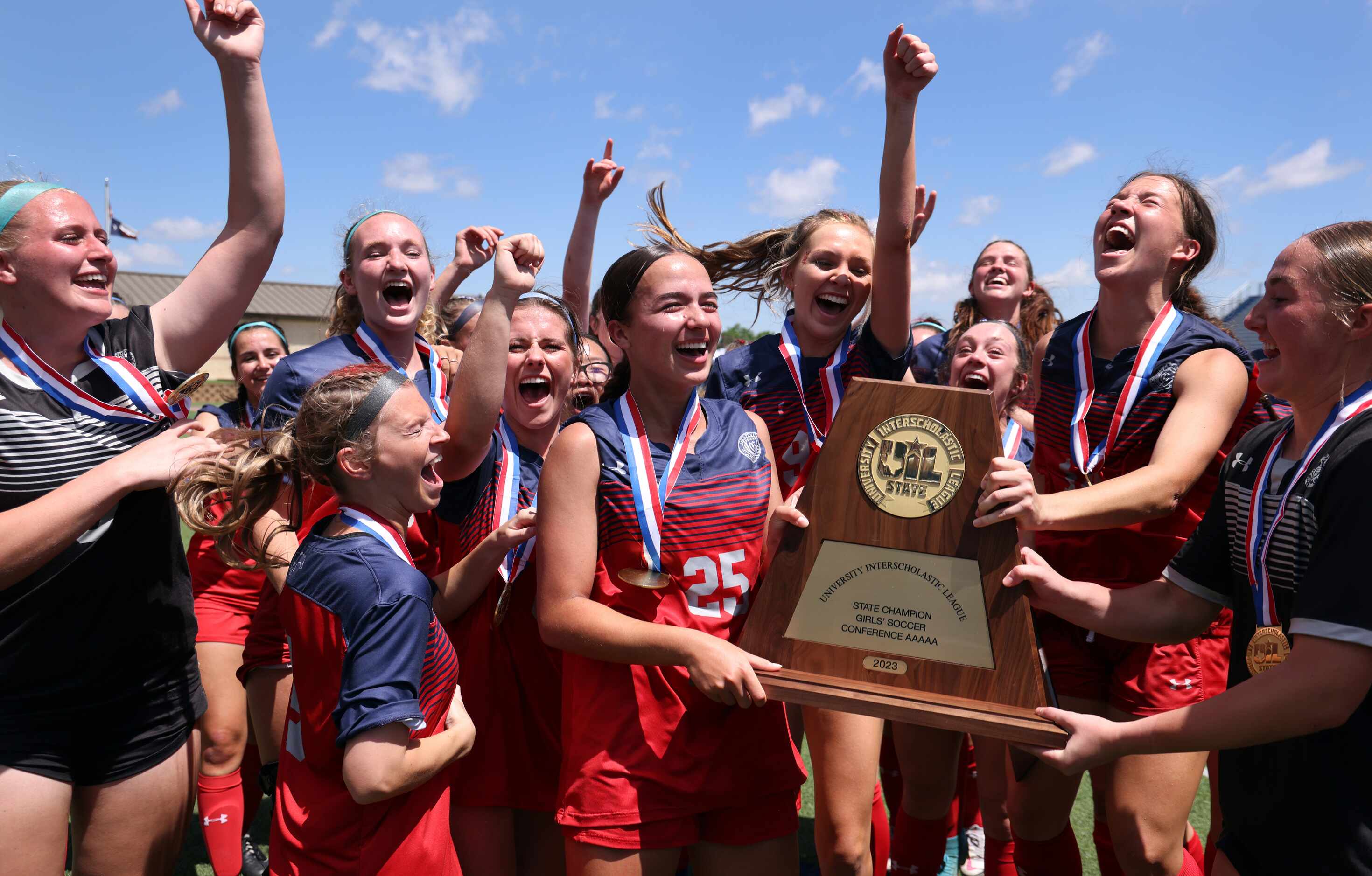 Grapevine players erupt near the team bench area after being presented the Class 5A state...