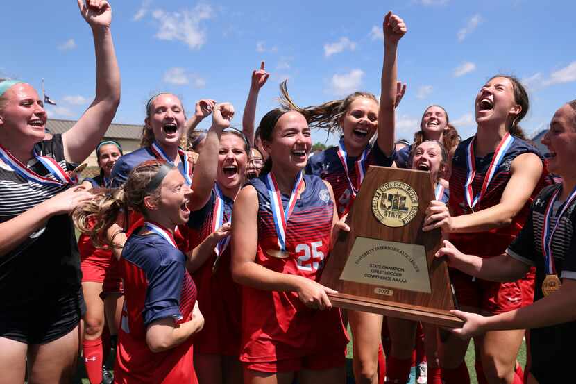 Grapevine players erupt near the team bench area after being presented the Class 5A state...