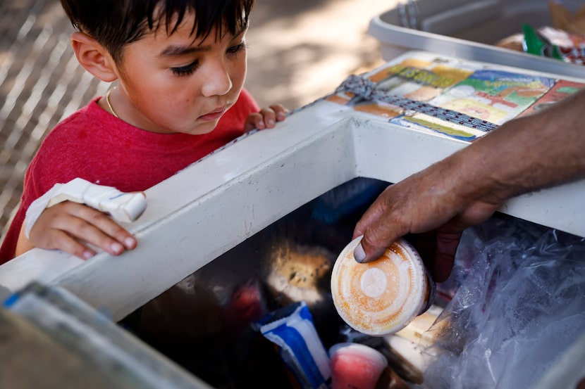 Rolo Trujillo, 4, eyes frozen sugary treats in paletero Leonardo German Trejo’s cart in the...