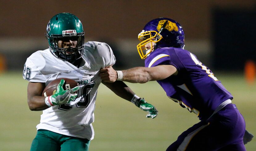 Abilene Wylie defensive back Cameron Hanna (11) tries to grab Kennedale running back DJ...