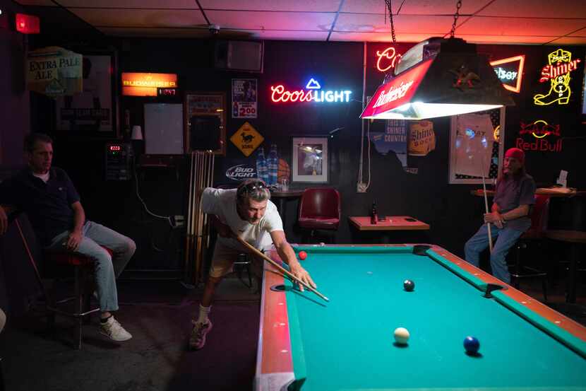 Darren Wilcox plays pool midday with Chad Wallace, on right, at what's been called one of...