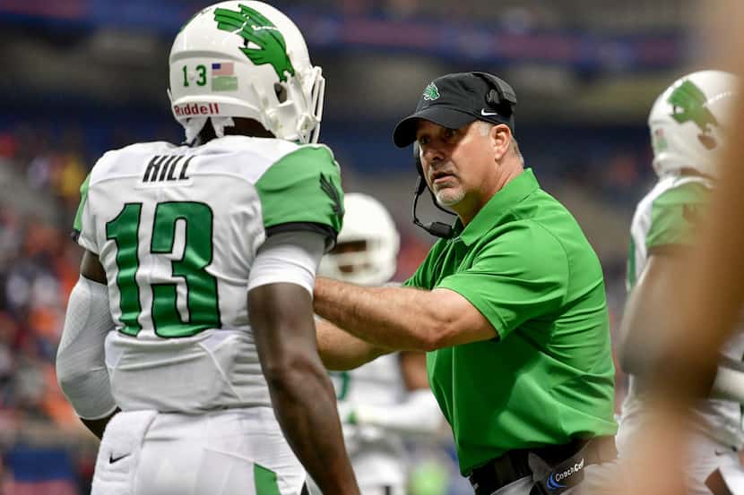 North Texas defensive coordinator Troy Reffett talks with former Mean Green defensive back...
