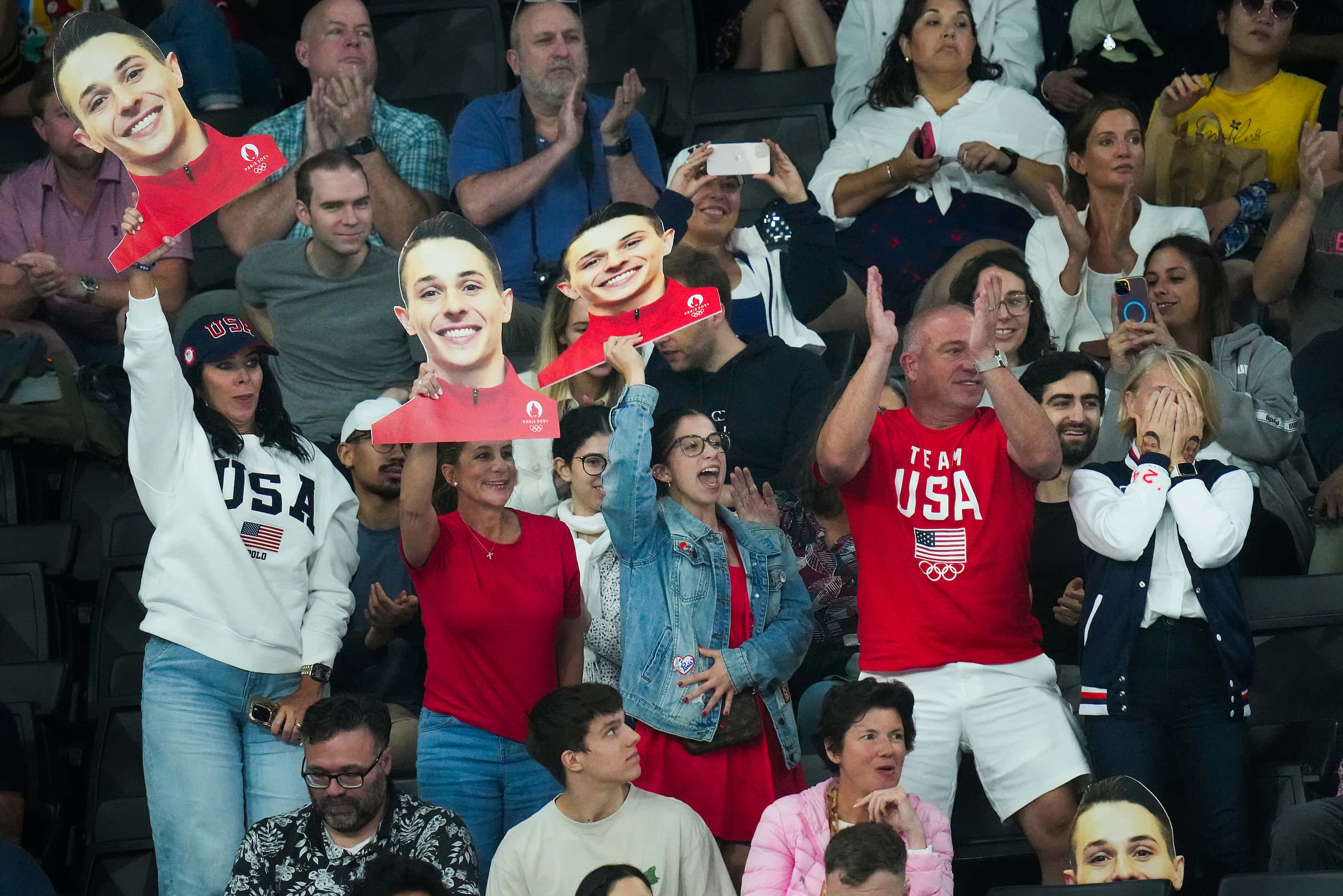 Paul Juda of the United States is cheered by his family during men’s gymnastics qualifying...