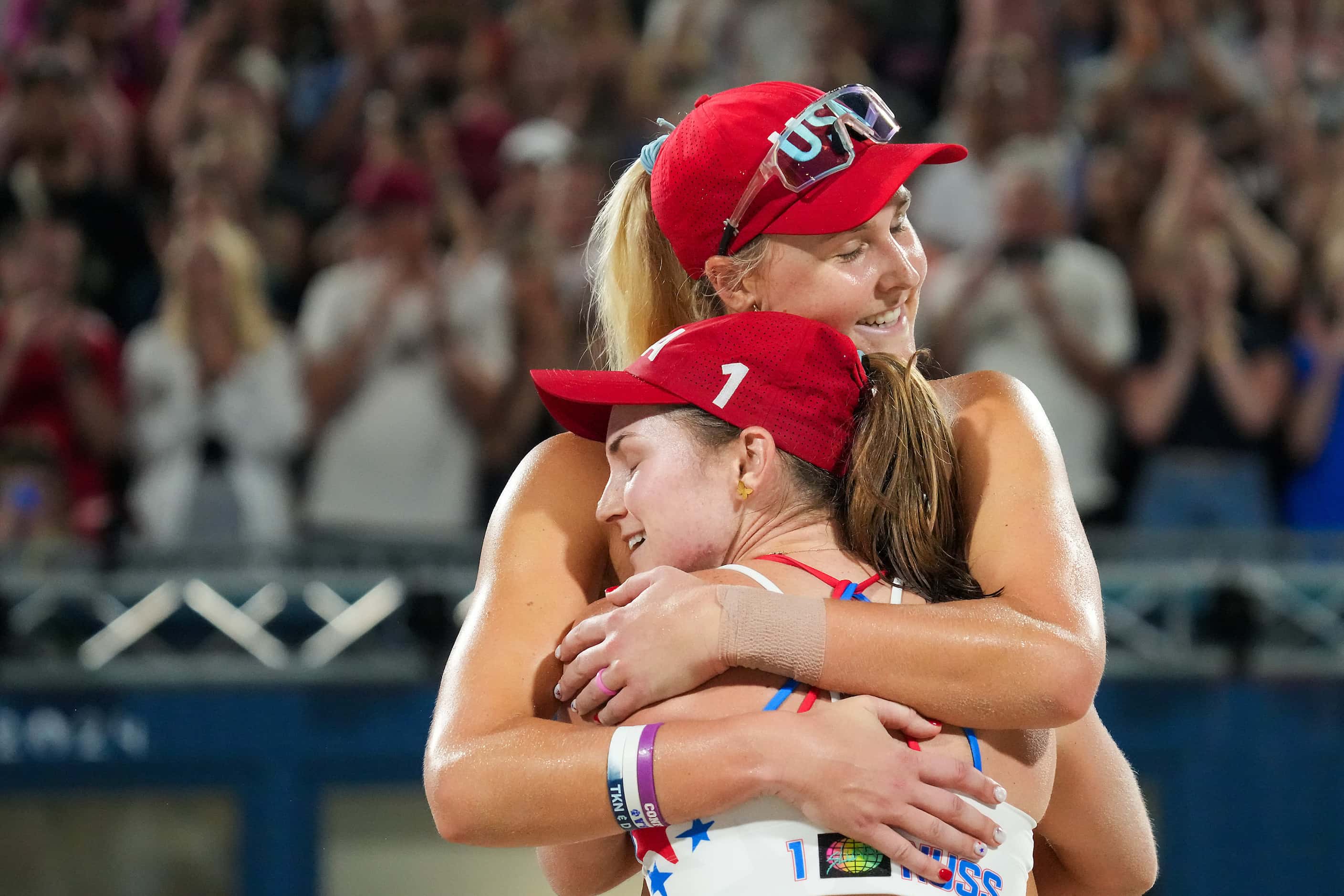 Taryn Kloth (facing) celebrates with Kristen Nuss after a victory over Artacho del Solar and...