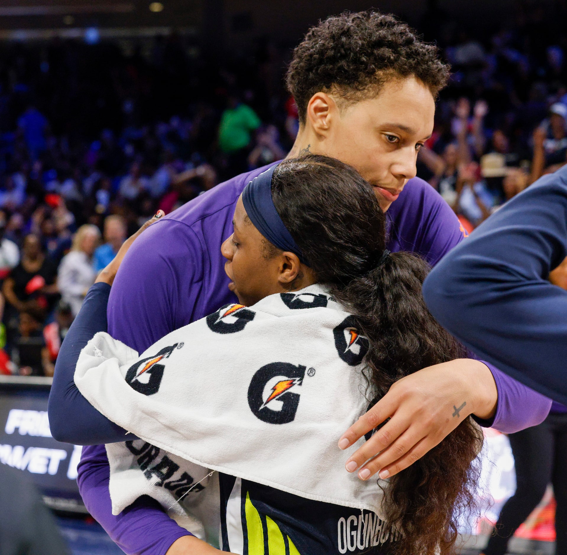 Dallas Wings guard Arike Ogunbowale (24) embraces Phoenix Mercury center Brittney Griner...