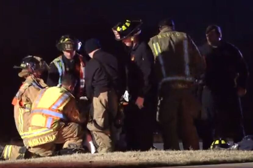Firefighters and paramedics gathered around a bicyclist who was struck by a car overnight in...
