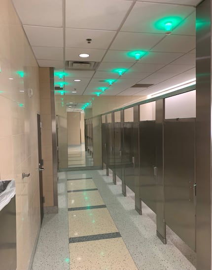 Bathrooms at DFW International Airport include light sensors to indicate which stalls are...