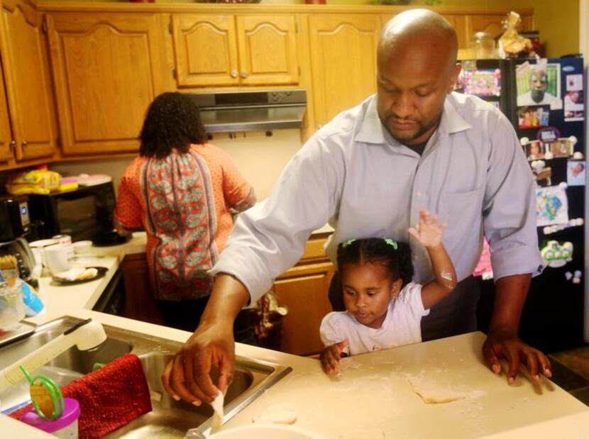 
Jamal Sterling makes beignets with his daughter India, 3, and his wife Nicole Sterling (in...