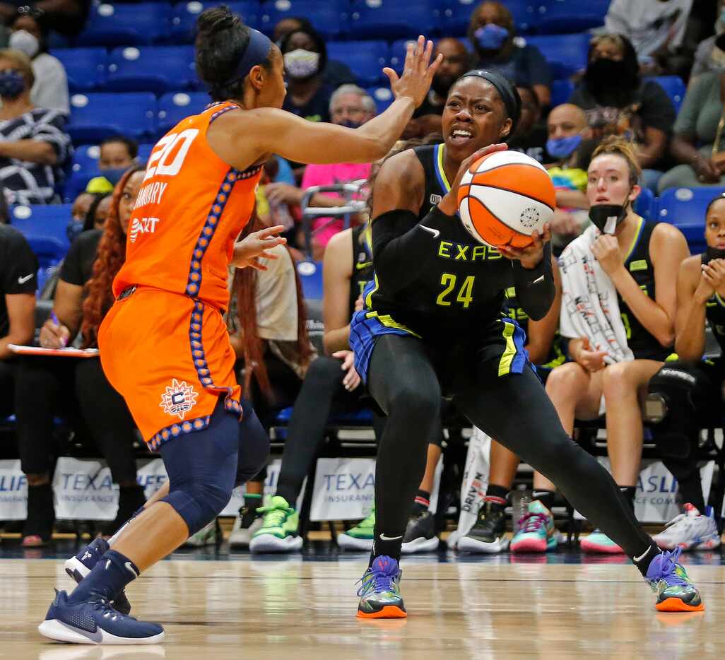 Dallas Wings guard Arike Ogunbowale (24) goes up for a shot as Connecticut Sun guard Briann...