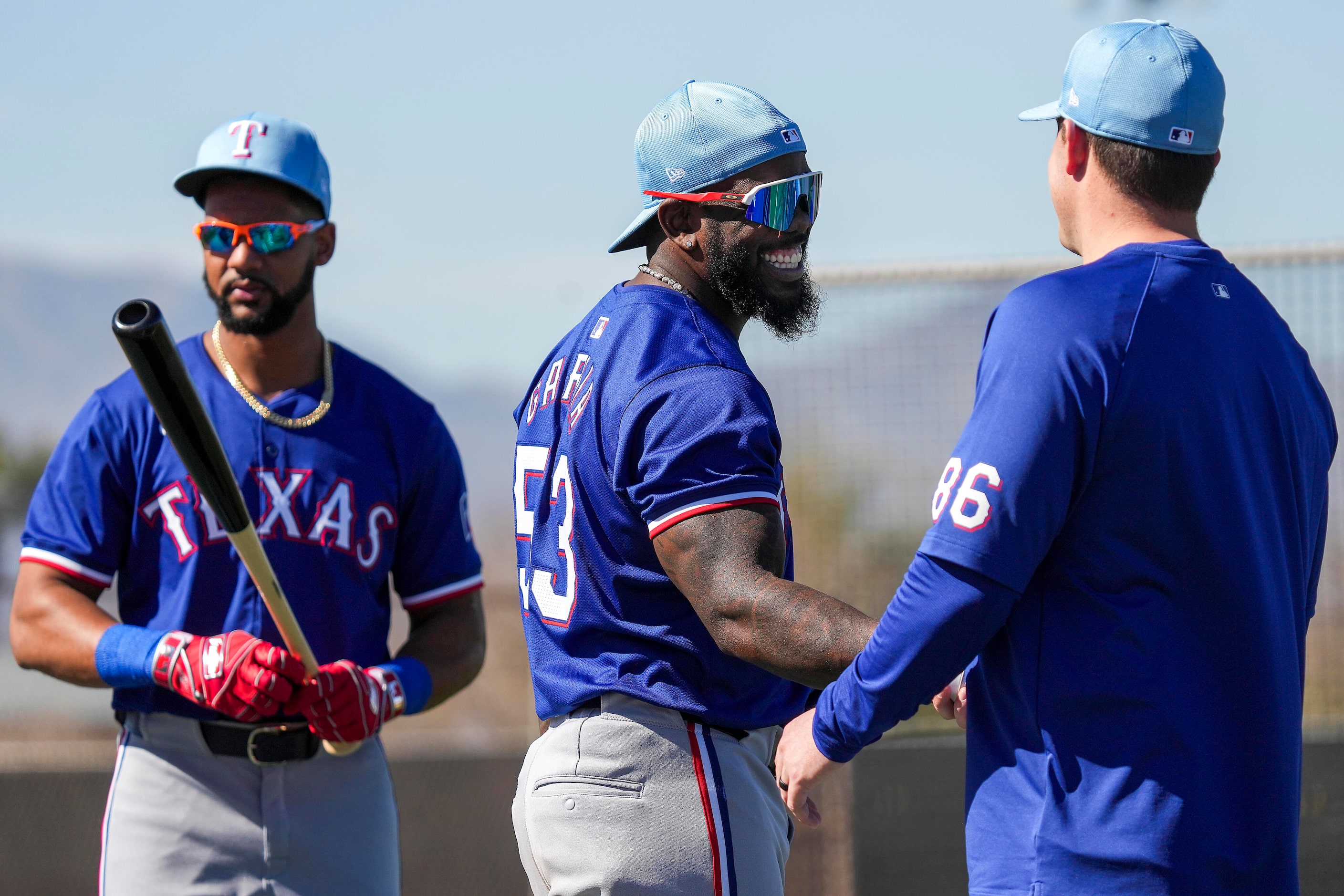 Texas Rangers outfielder Adolis García (53) greets assistant hitting coach Seth Conner (86)...