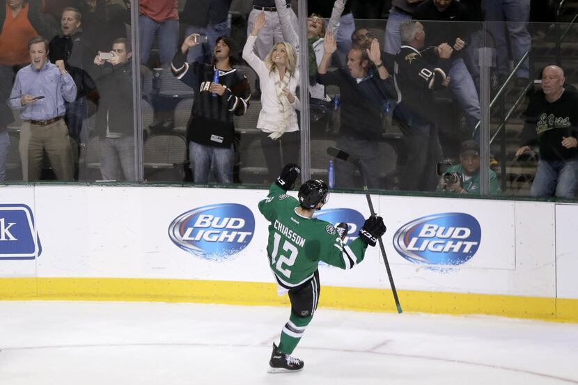 Fans celebrate with Dallas Stars' Alex Chiasson (12) after his shootout goal against the San...