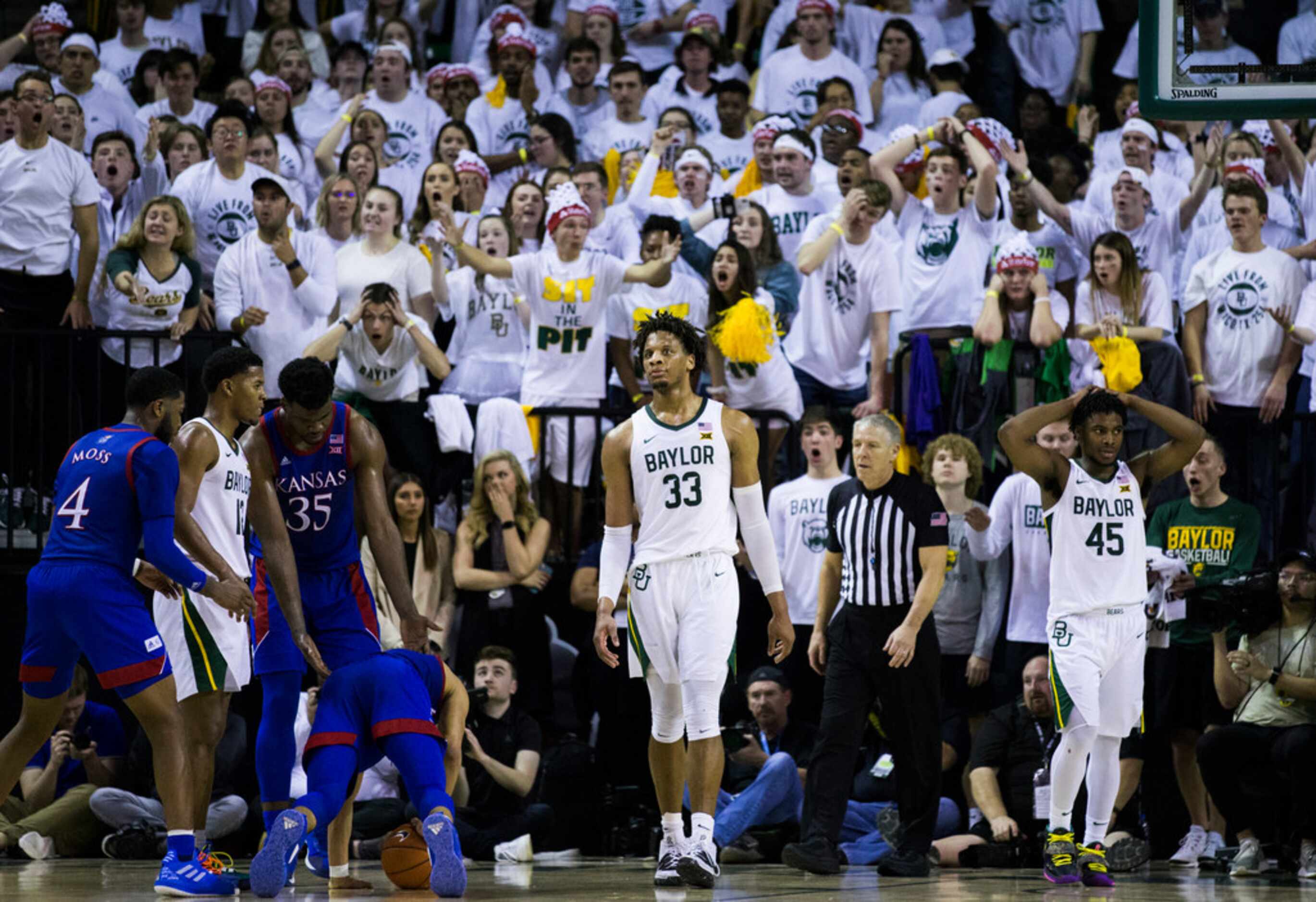 Baylor Bears forward Freddie Gillespie (33) and guard Davion Mitchell (45) react to a foul...
