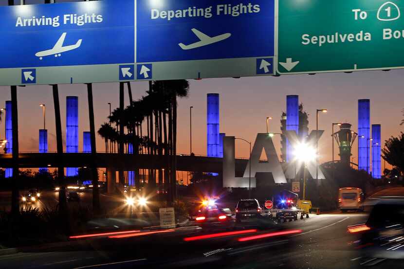 Lighted pylons at the Century Boulevard entrance to Los Angeles International Airport, which...