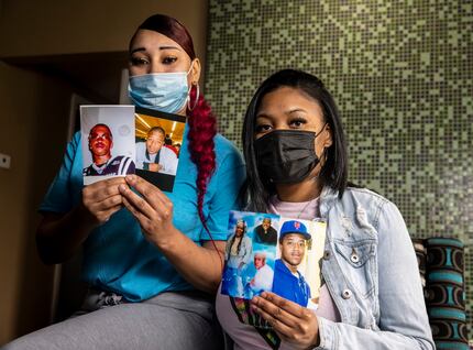 Cousins Nicole Hill (left) and Netia Smith hold photos of deceased brothers Isaac (second...