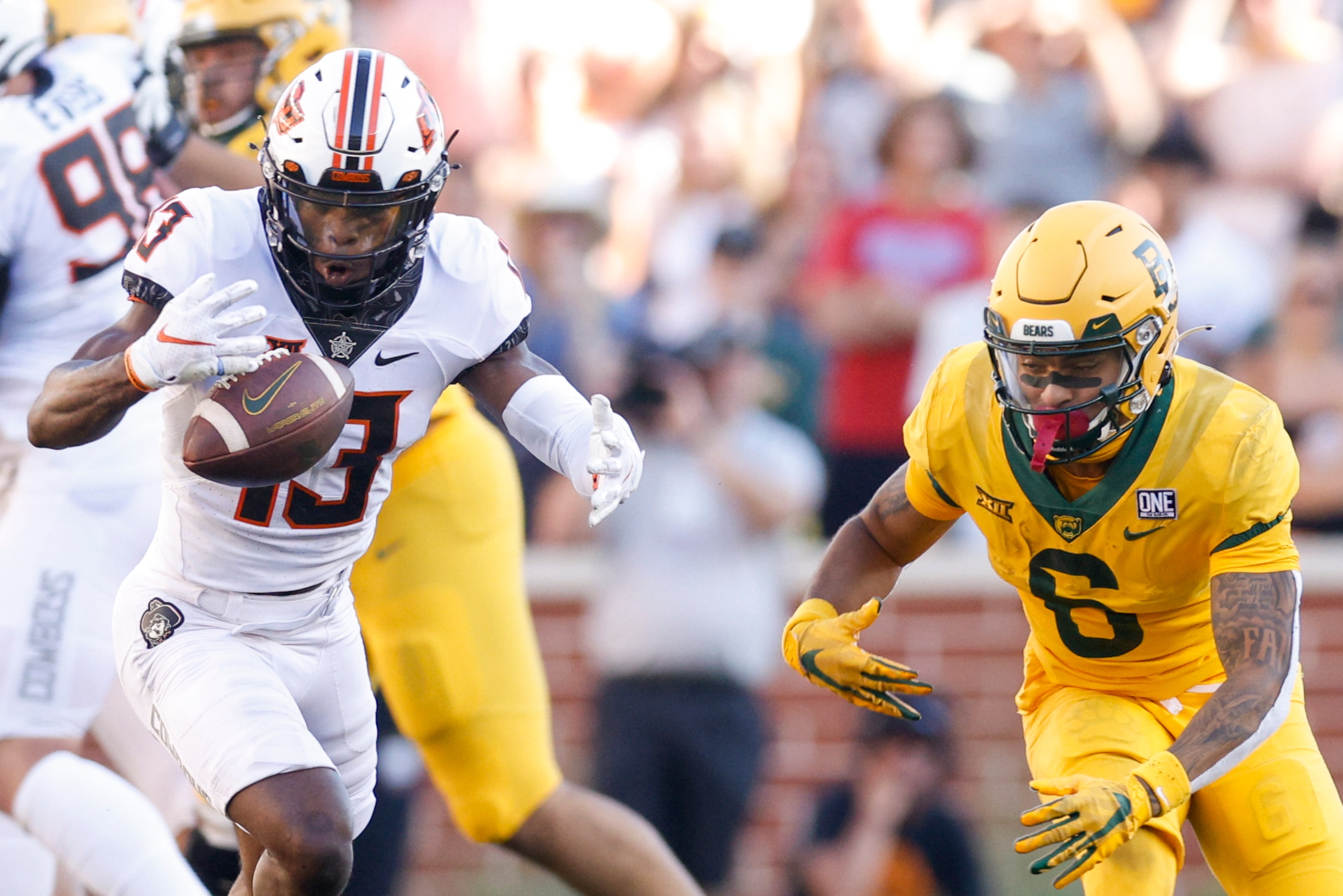 Oklahoma State safety Thomas Harper (13) intercepts a pass intended for Baylor wide receiver...