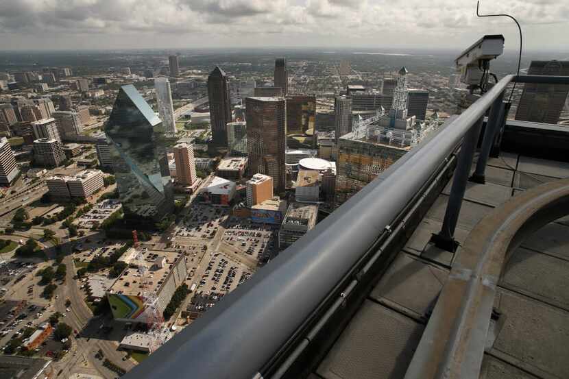 A surveillance camera sits atop Bank of America Plaza in downtown Dallas.