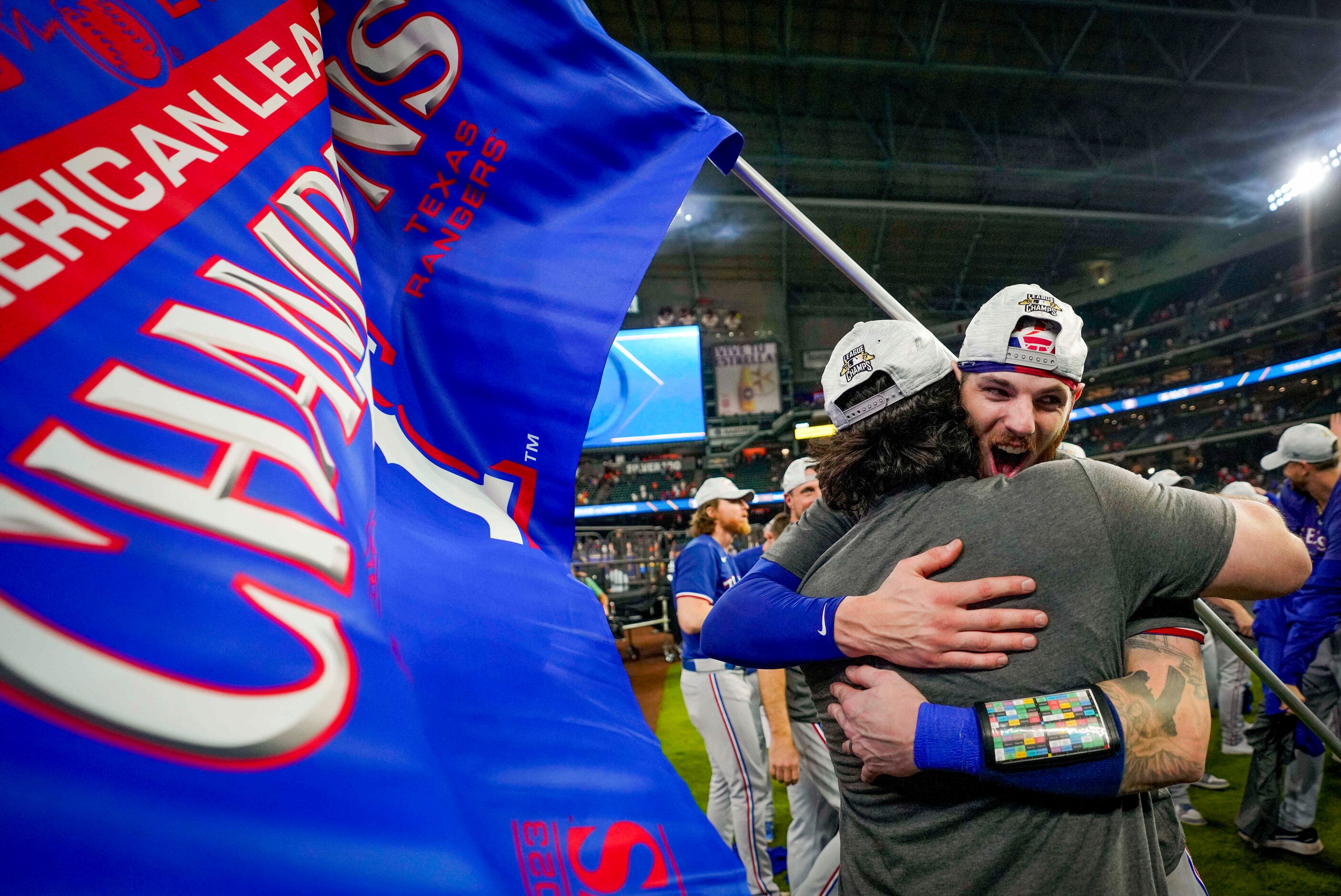 Texas Rangers catcher Jonah Heim (facing) hugs Austin Hedges as they celebrate after a...