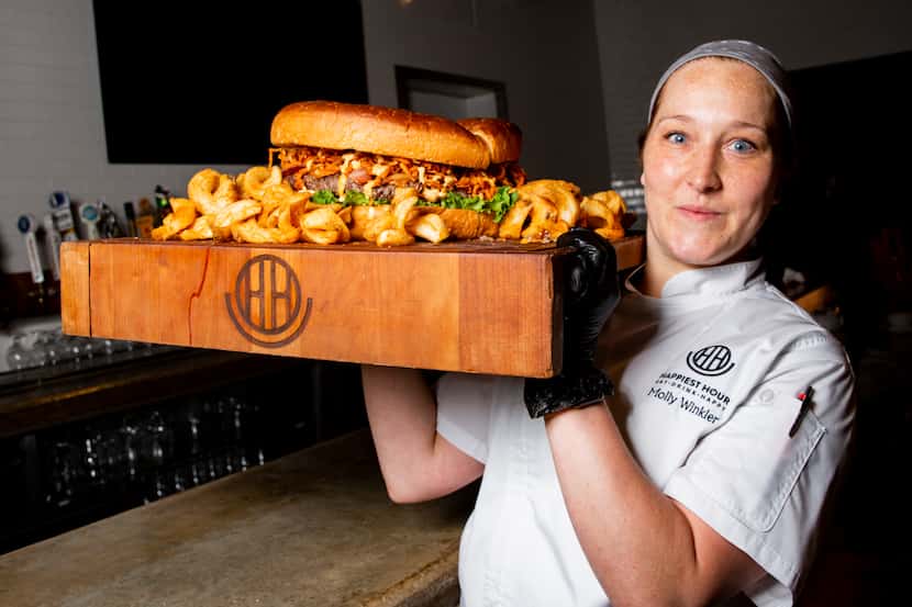 Executive chef Molly Winkler carries the 5-pound Big Happy Burger and 5 pounds of fries at...