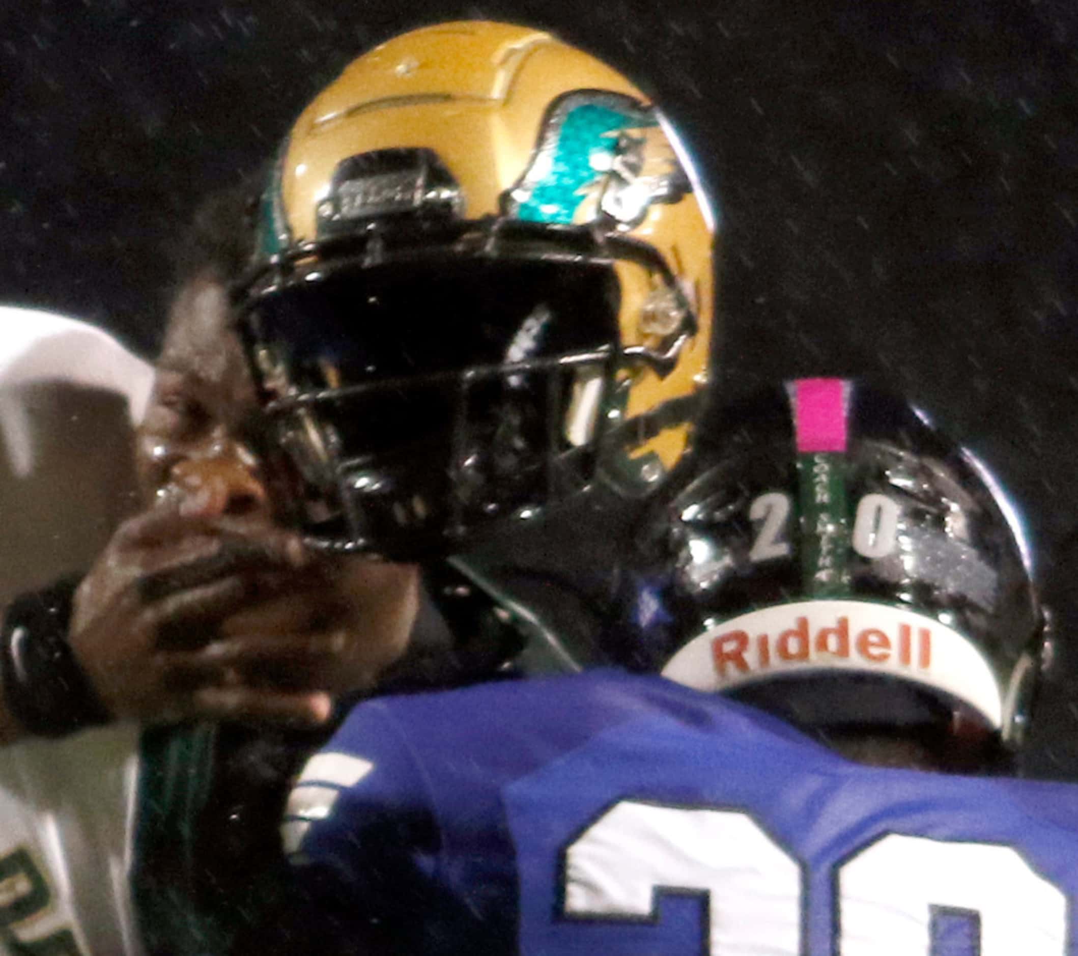 DeSoto quarterback Samari Collier (6) lose his helmet as he takes a hit from Mansfield...