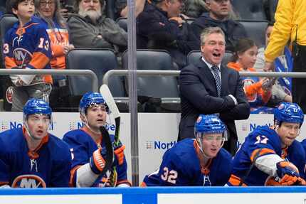 New York Islanders head coach Patrick Roy, upper right, watches the action during the first...