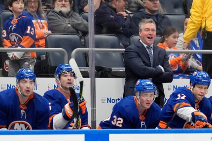 New York Islanders head coach Patrick Roy, upper right, watches the action during the first...