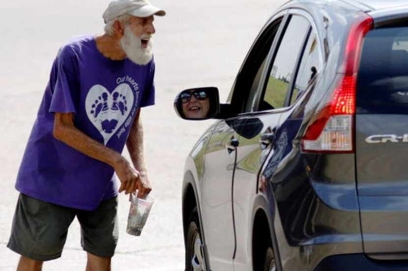 A panhandler worked a Dallas intersection last September. Some city council members want the...
