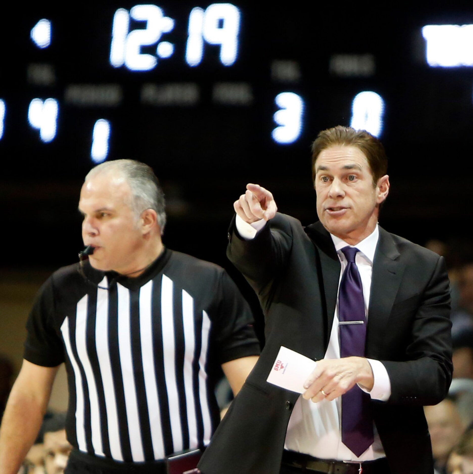 SMU head coach Tim Jankovich makes a point as he directs his players from the team bench...