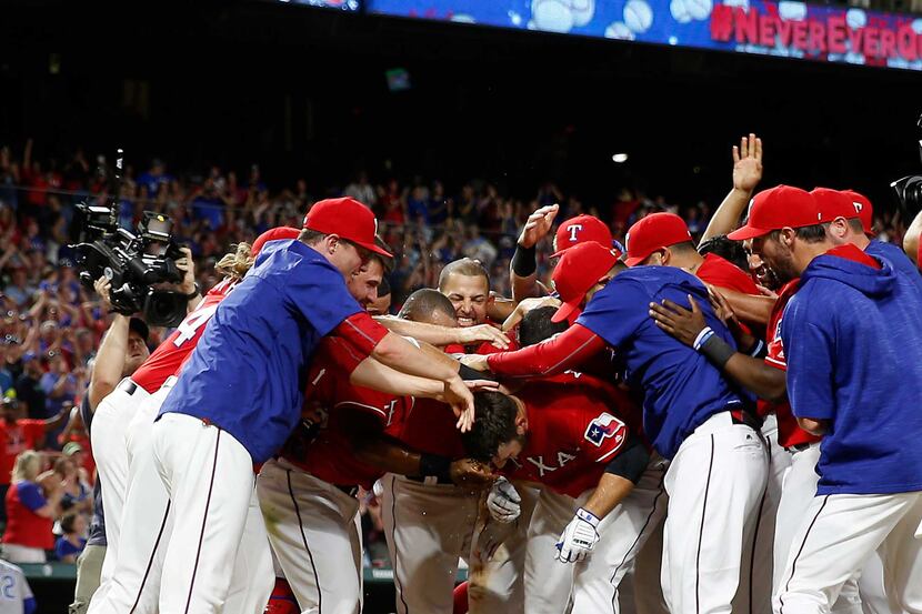 Texas Rangers first baseman Mitch Moreland (18) is congratulated by teammates after hitting...
