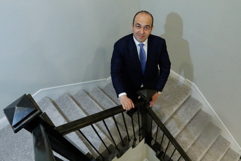 Zach Ipour, co-founder of Megatel Homes, poses on the stairs of the model home at the Mercer...