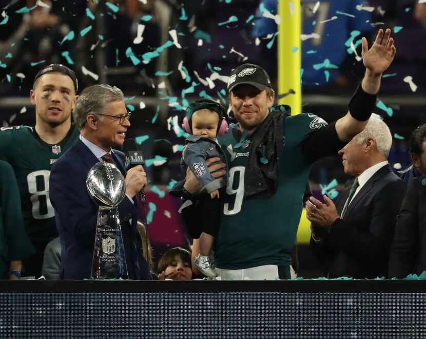 Philadelphia Eagles quarterback Nick Foles (9) holds his son and waves during the victory...