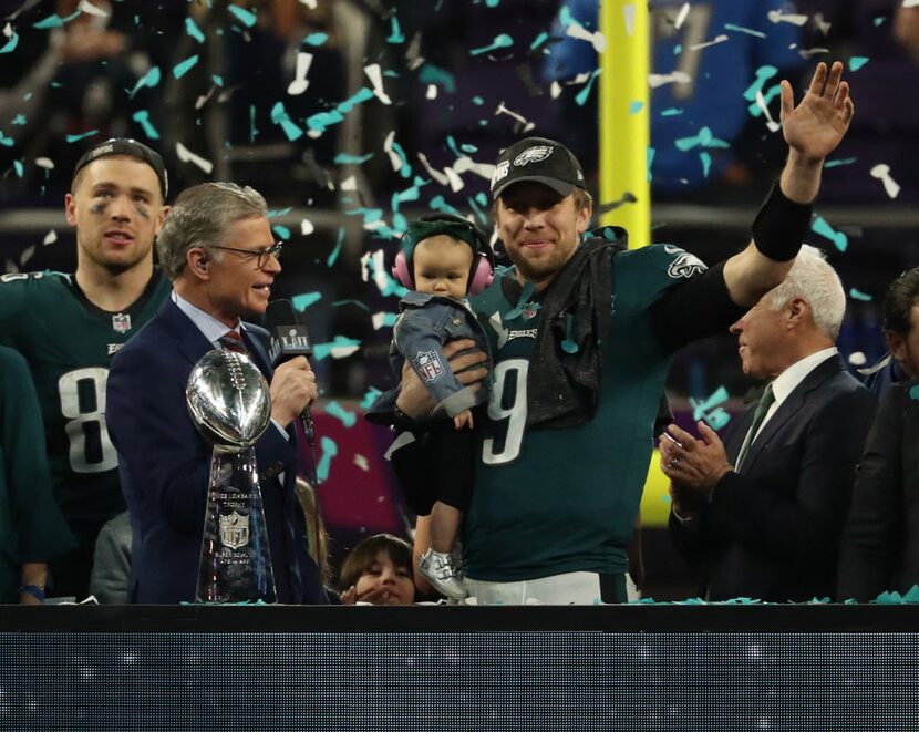 Philadelphia Eagles quarterback Nick Foles (9) holds his son and waves during the victory...