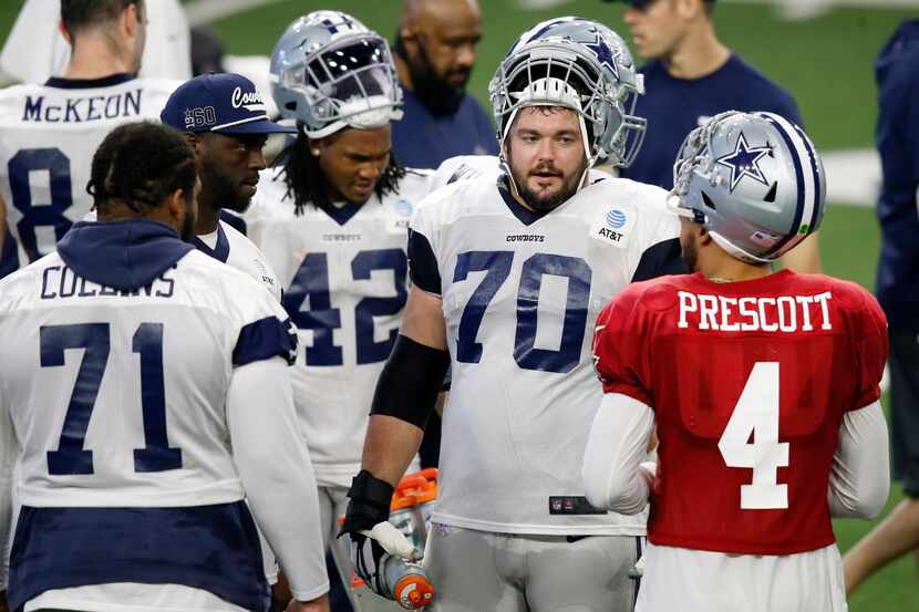 Dallas Cowboys quarterback Dak Prescott (4) talks with Dallas Cowboys guard Zack Martin...
