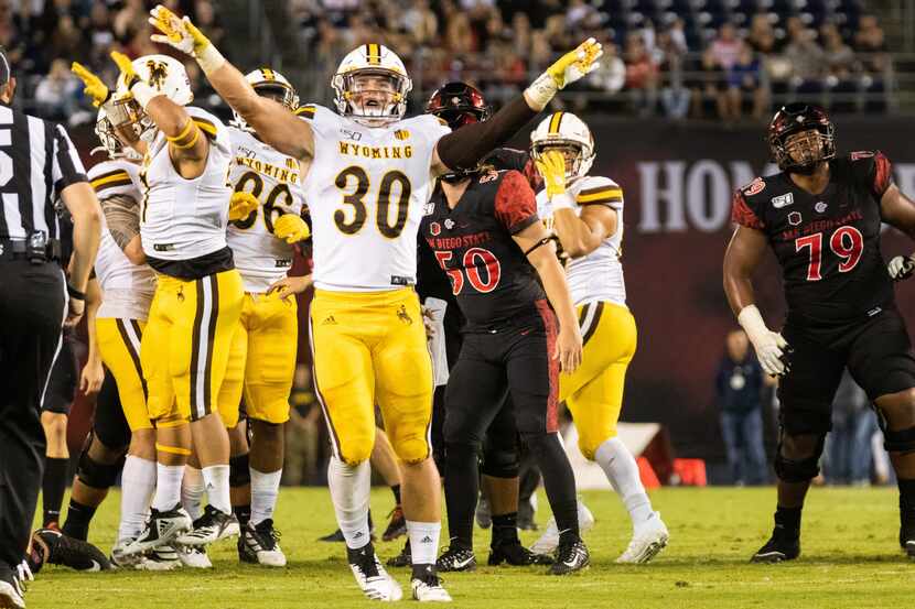 File - Wyoming linebacker Logan Wilson (30) celebrates a missed field goal by San Diego...