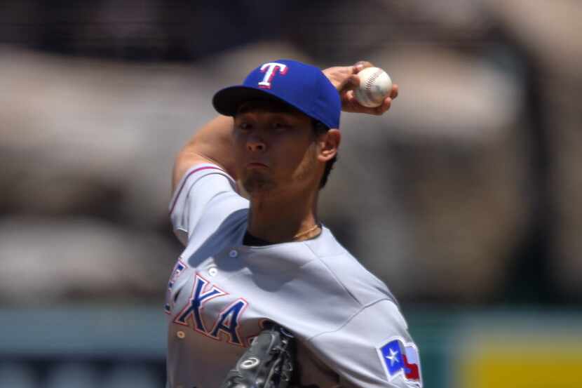 Texas Rangers starting pitcher Yu Darvish, of Japan, throws to the plate during the first...
