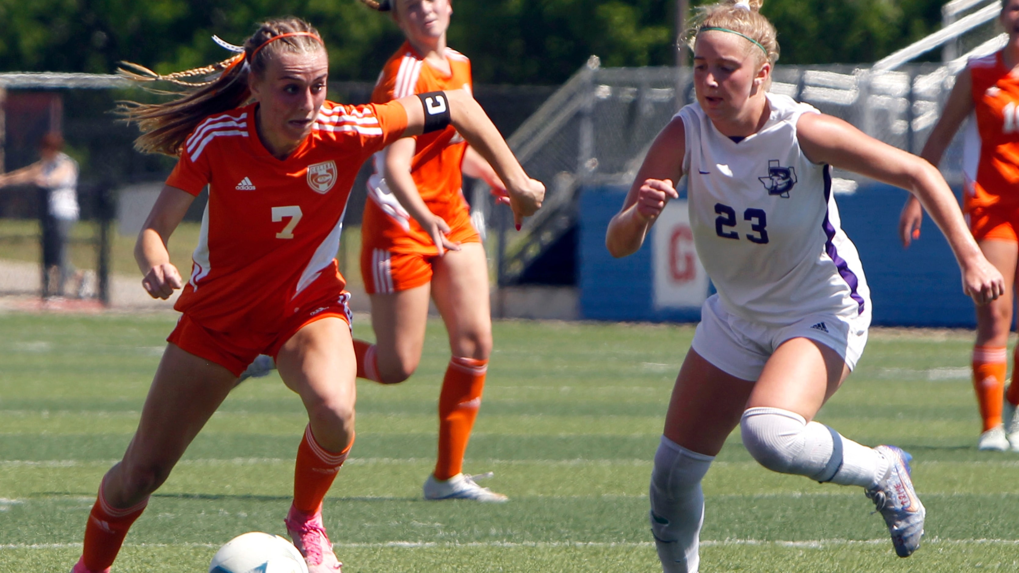 Celina's Lexi Tuite (7) eyes the goal as she scores over the defense of Boerne's Madeline...